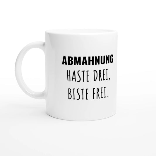 Weiße Keramiktasse 325 ml mit Aufdruck "Abmahnung – haste drei, biste frei" – Schreibtischtasse von Vollzeitfrust, Ansicht von links
