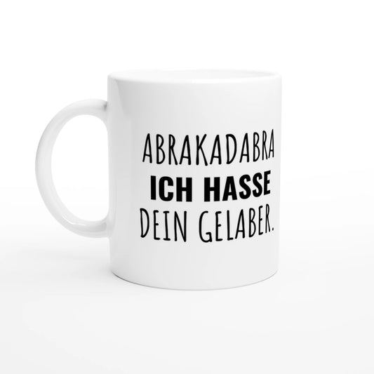 Weiße Keramiktasse 325 ml mit Aufdruck "Abrakadabra – Ich hasse dein Gelaber" – Schreibtischtasse von Vollzeitfrust, Ansicht von links
