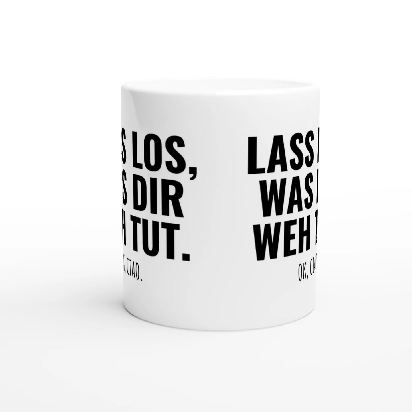 Weiße Keramiktasse mit Aufdruck "Lass los, was dir weh tut" – Rundumsicht der Bürotasse von Vollzeitfrust
