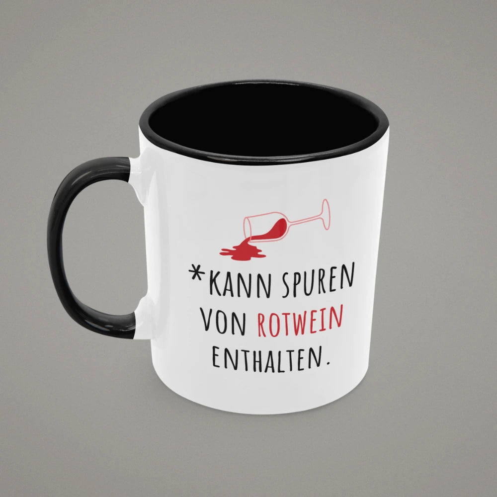 Zweifarbige Keramiktasse mit schwarzem Henkel und schwarzer Innenseite, Aufdruck „*Kann Spuren von Rotwein enthalten.“ mit umgekipptem Rotweinglas – lustige Tasse mit Spruch von Vollzeitfrust